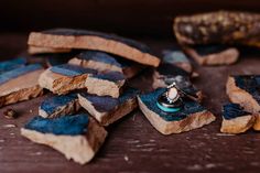 a couple of rings sitting on top of some pieces of wood next to a banana