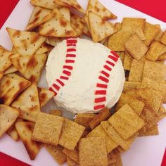 a plate with crackers, crackers and a baseball ball on top of it