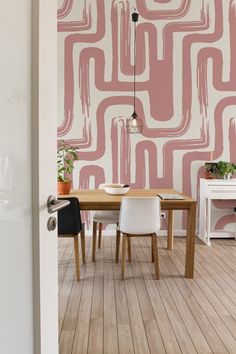 a dining room with pink and white wallpaper