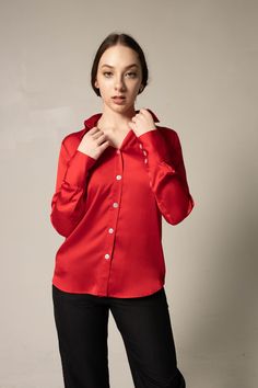 . Color: Red. Length: 30 inches. Made in America. Care: Dry Clean. Composition: 100% silk charmeuse. Sizing: • Fits true to size • Designed for a regular fit • Mid-weight, non-stretchy fabric • Model is 5ft 8 in/ 172.72 cm, and wears a size Small (2) Women Silk Shirt, Uniform Inspiration, Red Silk Shirt, College Graduate, Satin Long Sleeve, Chic Blouses, Satin Blouses, Luxury Silk, Trendy Tee