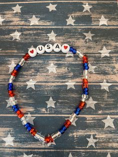 This is a USA Patriotic beaded bracelet. It would make a great addition to a woman's or teen's 4th of July outfit. It would make a great gift for a birthday gift. It has white USA letter beads. It has two heart beads. It has red, clear, and blue seed beads. It was made with .8mm sturdy stretch string. I tie it several times to prevent breakage. It fits most teens and women. It stretches to fit on the wrist. All items are ready to be shipped I do combined shipping. Items ship in 2-5 business days. Check out more items at: http://www.etsy.com/shop/MesheleCrafts  https://www.facebook.com/MesheleCrafts Usa Bracelet, Patriotic Bracelet, Bloomington Illinois, 4th Of July Outfit, 4th Of July Outfits, Usa Patriotic, Fits Women, Letter Beads, Two Hearts