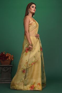 A very unique saree with Handloom Cotton Silk fabric till the pleats and Chanderi fabric with Bronze motifs which is translucent in the front. It also has a Pallu with bronze weave and fringes which makes the whole saree really exquisite. The entire saree has a Golden border. Enhance with a beautiful floral pattern, the vintage design enhances the royal look of the saree. Made with an intricate technique, this is a heritage of its own kind. With a rich border enveloping the saree, it is a stella Pre-draped Chanderi Saree With Sheer Dupatta, Transitional Tissue Silk Pre-draped Saree, Transitional Yellow Tissue Silk Pre-draped Saree, Transitional Tussar Silk Saree With Sheer Dupatta, Elegant Handloom Saree For Reception, Cotton Silk Saree With Self Design For Reception, Reception Cotton Silk Saree With Self Design, Chanderi Pre-draped Saree With Pallu, Floor-length Organza Pre-draped Saree With Sheer Dupatta