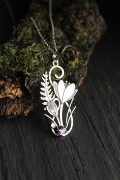 ITEM DESCRIPTION: The size H 5 cm x W 3 cm (2 x 1 inch). Weight - 4 g. You can buy it with a silver chain or without it. I made this unique Crocus pendant of sterling silver, dark amethyst, and moonstone. This is similar to the first spring flowers that appear from under the snow. The floral necklace looks so gentle and elegant! This handmade necklace will come to you in a gift box - ready for gifting. The parcel will be sent 1-2 days after payment. Delivery usually takes 10-21 days. But in the Nature-inspired Flower Pendant Jewelry For Mother's Day, Silver Necklace With Flower Charm For Spring, Silver Necklaces With Flower Charm For Spring, Silver Flower Pendant Necklace For Mother's Day, Nature-inspired Flower Charm Pendant Necklace, Spring Sterling Silver Jewelry With Flower Charm, Spring Birth Flower Jewelry, Birth Flower Jewelry For Spring, Nature-inspired Flower Charm Pendant Jewelry