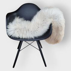 a black chair with a white fur on it