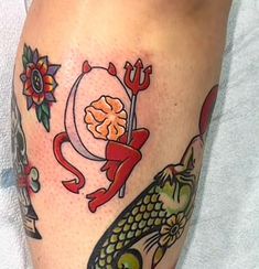 a tattoo on the leg of a woman with fish and anchor, moon and star