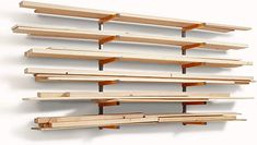 a wall mounted shelf with several wooden shelves on each side and one above the other