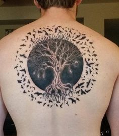 a man with a tree tattoo on his back