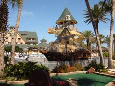 a miniature pirate ship is in the middle of a miniature golf course at disney's beach resort