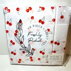 the package is wrapped in white paper with red cherries on it, and has a label that says 6 piece frosty bake