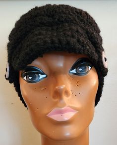 a mannequin head wearing a black knitted hat