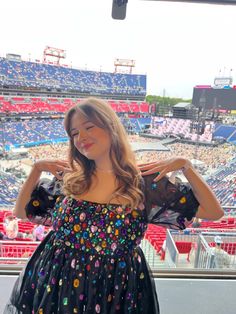 a woman standing in front of an empty stadium