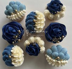 blue and white cupcakes decorated with pearls