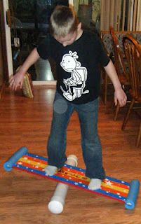 a young boy is playing with a toy on the floor