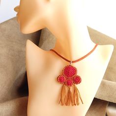 This crochet necklace is designed and created by me. It is inspired by the ancient Greek jewelry and is delicate and elegant with a perfect combination of bright red and camel brown colours. It comes with a leather strap in camel brown colour. MEASUREMENTS: Pendant Motif height 7 cm Pendant Motif width   4 cm Leather Strap length     45 cm You can see more designs of small crochet necklaces in my Shop by visiting  the Small Crochet Necklaces Section  following the link below: https://www.etsy.co Brown Tassel Necklaces As Gifts, Adjustable Bohemian Red Coral Necklace, Yellow Crochet Bohemian Jewelry, Bohemian Brown Crochet Jewelry, Adjustable Crochet Necklaces With Round Beads, Brown Bohemian Crochet Jewelry, Bohemian Red Pendant Beads, Red Bohemian Crochet Jewelry, Tassel Necklace Boho