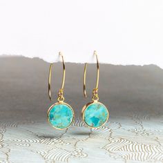 Turquoise Gold Drop Earrings - Long Gold Drop Statement Earrings Perfect for Bridesmaids, Mom, Grandmother, Wife, Daughter, 14k Gold Filled NECKLACE SOLD SEPARATELY Stone: Genuine Turquoise Please note due to nature of our genuine stones no two are alike and the ones you will receive will vary slightly from the ones pictured in the photos. Bezel: Vermeil Gold Ear-wire: 14k Gold Filled Total length of earring: 35mm Circle Gemstone: 12mm diameter About "Gold Filled Jewelry": Also called rolled-gol Turquoise Birthstone Round Earrings, Turquoise Round Birthstone Earrings, Gold Filled Necklace, Statement Drop Earrings, Earrings Long, Genuine Turquoise, Gold Drop Earrings, Gold Filled Jewelry, Necklace Earring Set