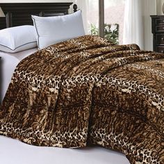 a leopard print comforter set on a bed