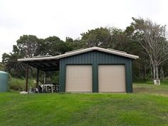 two garages in the middle of a grassy field