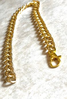 a gold chain is shown on a white surface