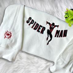 Introducing our Miles Morales Embroidered Crewneck T-Shirt, a must-have for all Marvel fans! Made with high-quality materials, this sweatshirt offers Spiderman Shirt, Toy Story Shirt, Hawaiian Shirt Women, Cartoon Sweatshirts, Embroidered Crewneck, Miles Morales, Sweatshirt For Men, Embroidered Clothes, Embroidered Sweater