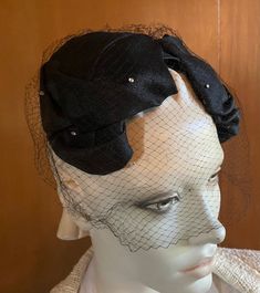 Classic and stylish 1950s crescent hat is crafted of quality textured black fabric. Full face veil adds allure and mystique. Sweet vintage rhinestones provide subtle sparkle to both hat and veil pieces. Instantly snazz up a solid black dress or suit with this lovely retro accessory piece One size fits all circa 1950s Headpiece will be carefully wrapped and placed into a secure box for shipping For more fabulous finds Please visit our boutique https://www.etsy.com/shop/chicvintageclassics?ref=hdr Vintage Formal Headband Costume Hat, Vintage Formal Costume Headband, Vintage Evening Fascinator Headband, Vintage Headband Fascinator For Church, Vintage Fascinator Headband For Church, Vintage Church Fascinator With Headband Shape, Vintage Church Fascinator Headband, Vintage Evening Headband Headpiece, Vintage Headband Headpiece For Evening