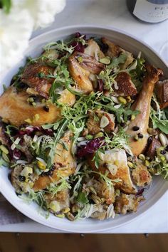 a white bowl filled with food on top of a table