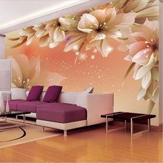 this living room is decorated in pink and white with large flowers on the wall behind it