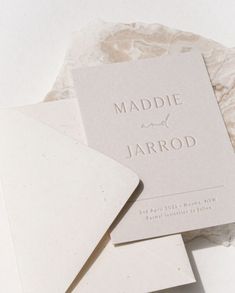 the wedding stationery is laid out on top of each other, and it looks like marble