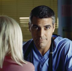 a male doctor talking to a blonde haired woman