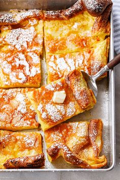 some food is sitting on a pan and ready to be eaten with a serving spoon