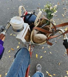 a person riding a bike with a basket full of items