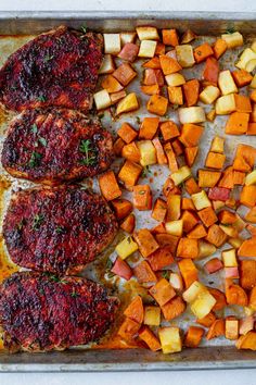 roasted vegetables and meat on a baking sheet