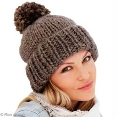 a woman wearing a knitted hat with a pom - pom