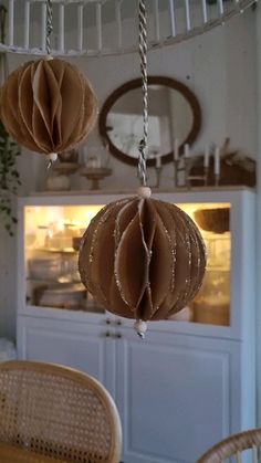 some brown paper balls hanging from a ceiling