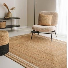 a living room with a chair and rug on the floor