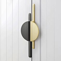 a white door with a black and gold handle