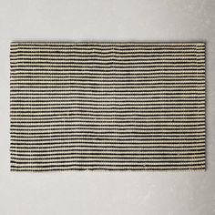 a black and white striped rug on the wall