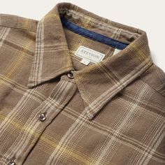 This button-front flannel shirt features an exclusive brown plaid pattern and is crafted from 100% cotton that has been yarn-dyed for rich, lasting color. It has no front yoke, a shallow straight back yoke with pleats, square pockets with flaps and button closures, two-button adjustable cuff, as well as contrast inside denim trim. Cut in our Modern Fit, for a trim, neat appearance that allows for comfort and freedom of movement. Exceedingly durable and always comfortable, our shirts are hard-wea Earthy Clothes, Brown Flannel, Allen Solly, Sleeve Placket, Photography Product, Vintage Flannel, Straight Back, Mens Flannel Shirt, Fashion Suits For Men