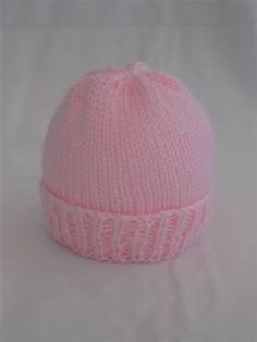 a pink knitted hat on a white background