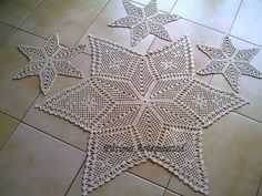 three crocheted stars are on the floor