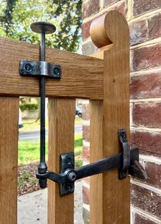 a close up of a wooden gate with metal latches on the side of it