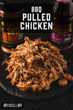 barbecue pulled chicken on a black plate with bbq sauce in the background and text overlay