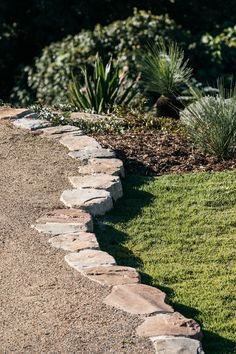 a stone path in the middle of a garden