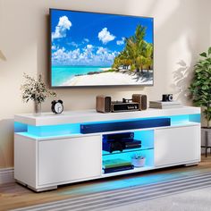 a flat screen tv sitting on top of a white entertainment center in a living room