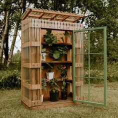 a wooden shed with plants growing in it