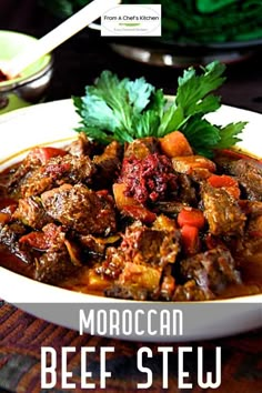 beef stew with carrots and parsley in a white bowl