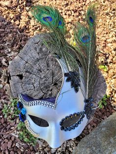 Silver masquerade mask with peacock feathers, blue & black rhinestones, and blue lace. One of a kind. I don't mass produce anything! I love to use supplies that I've collected from thrift shops or even the back yard. All items are handmade and may contain small imperfections.  As with all one-of-a-kind Items, this piece of art may not be recreated as each one is unique! Silver Masquerade Mask, Costume Masks, Costume Mask, Masquerade Mask, Peacock Feathers, Black Rhinestone, Blue Lace, Costume Accessories, Feathers