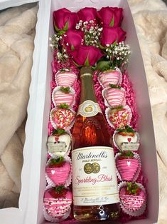 a bottle of wine and some strawberries in a box