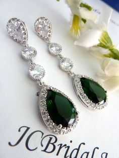 This classy earring features a long LARGE  emerald green peardrop cubic zirconia (20 X 15 mm) with multi small zirconias around it, dangling from 2 round cubic zirconia connectors,  with a white gold plated peardrop cubic zirconia post earring, the ear post is made of sterling silver.Size: 5.5 x 1.5 cm or about 2.6 inches long.Earring can be shorten to suit your need, just let me know :)The last picture shows an emerald green cubic zirconia worn by a mannequin.Other colour is also available:1. E Green Pear-shaped Teardrop Earrings, Green Teardrop Cubic Zirconia Earrings, Green Pear-shaped Earrings For Party, Classic Green Earrings For Party, Green Long Drop Earrings For Formal Occasions, Green Teardrop May Birthstone Earrings, Green Teardrop Earrings For May Birthstone, Pear-shaped Emerald Green Earrings, Elegant Green Long Drop Earrings