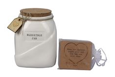 a white mason jar next to a wooden block with a heart on it and a rubber stamp