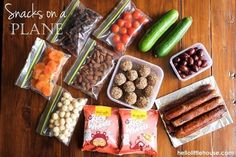 snacks on a table including carrots, beans, cucumbers and other foods